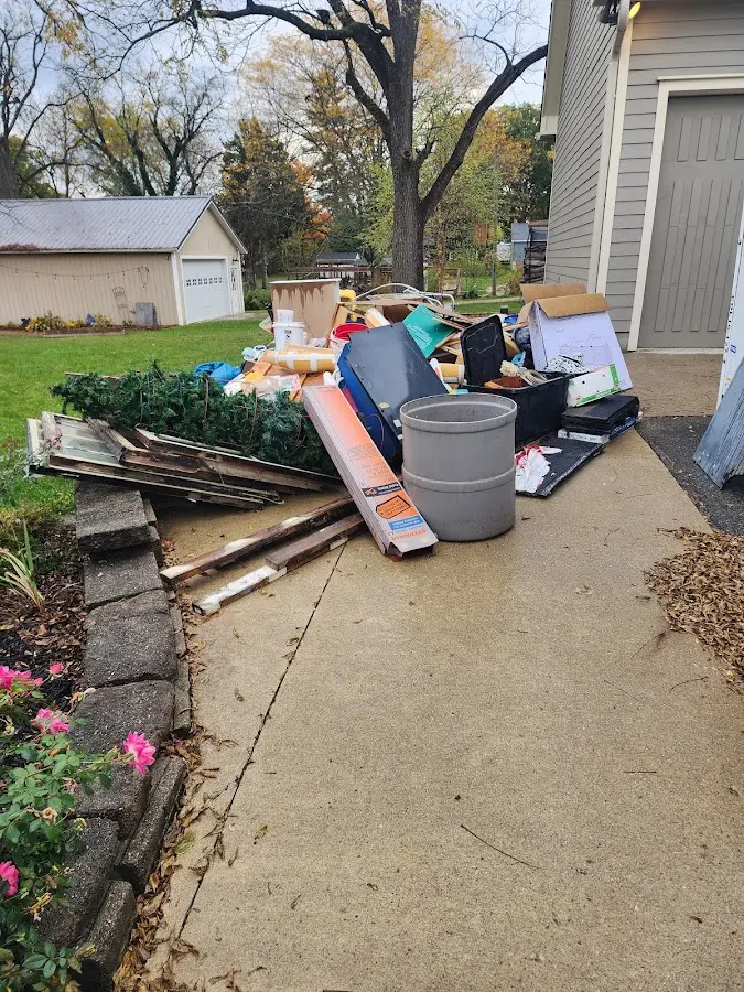 Dumpster being loaded with debris for Residential Dumpster Rental in Braddock